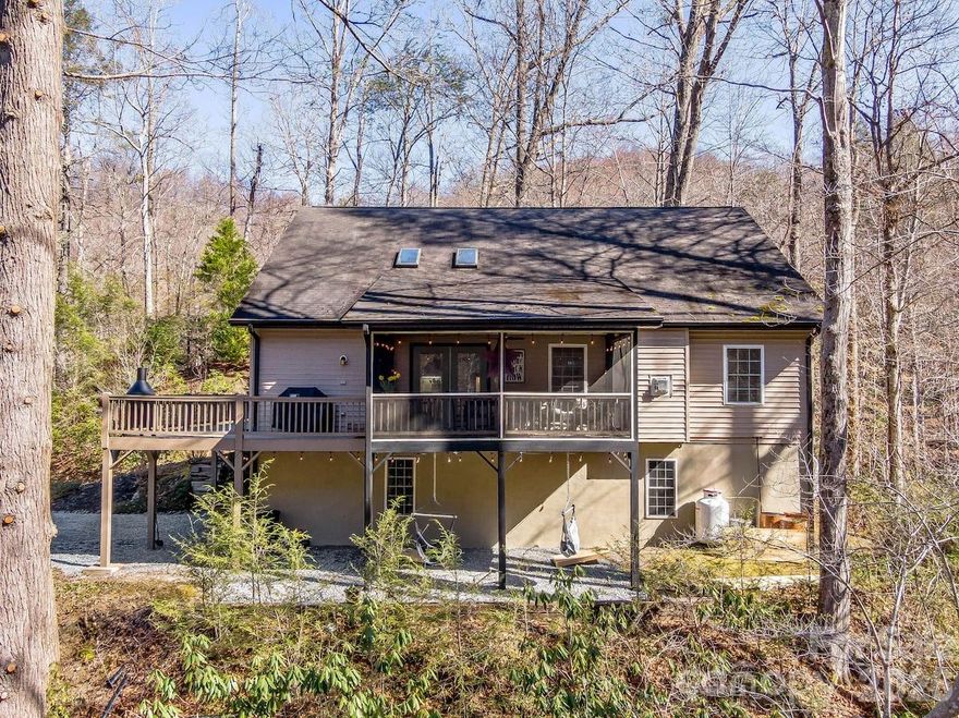Tucked along the Pacolet River just minutes from downtown Saluda, this private mountain retreat offers a rare combination of natural beauty, flexibility, and everyday livability. The home works beautifully as a primary residence, second home, or mountain getaway, with the added potential for short term rental use.
Set on nearly four acres with more than 800 feet of river frontage, the setting invites a slower pace. Morning coffee on the screened porch, evenings listening to the sound of rushing water, and easy access to a cleared path leading to a favorite fishing spot and a private waterfall all shape the experience here. Mountain views and wooded privacy create a true escape while still keeping you close to town. Discover your legacy in the making.
Inside, the home is warm and open with natural light and spaces designed for gathering and relaxing. The main level primary suite offers comfort and convenience, complemented by a dedicated office or den with fiber connectivity for remote work. Upstairs, additional bedrooms and baths provide room for guests and family, while multiple indoor and outdoor living areas make hosting feel natural and easy.
Life here centers around connection to nature and the charm of small town mountain living. Downtown Saluda is only minutes away with its restaurants, shops, and local events, while nearby trails, kayaking, tubing, and cycling offer year round adventure.
A large basement with tandem two car garage and generous storage adds everyday functionality to the home’s mountain setting.
This property offers privacy, direct access to the river, proximity to town, and the flexibility to serve as a full time residence, second home, or income producing rental opportunity.