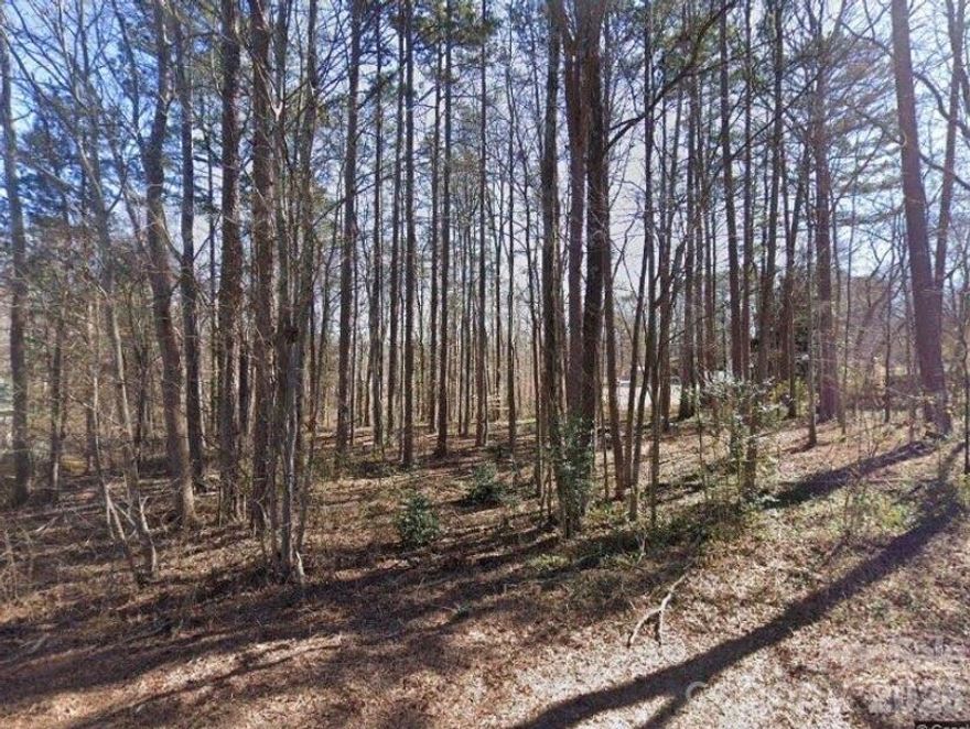 Gorgeous, wooded lot located in an established West Rowan neighborhood ready to build on.