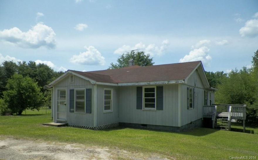 If you want country living, this one story home may be the one for you.  Make this two bedroom, two bath house a home with your renovation/update ideas.  It also features a spacious den, kitchen/dining area, two decks and enclosed front porch.  Go fishing in the shared pond located behind the house or just enjoy the wildlife it attracts.