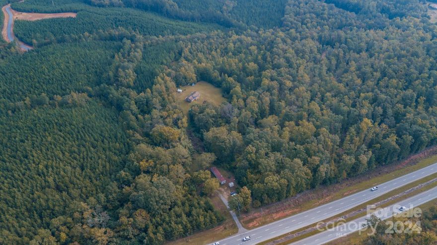 Looking for land to call your own? This 15+/- acre track is it. With no HOA just think about the potential. This property can be your own farm or split into multiple parcels. Per the county- it can be split into three 5 acre lots. On the property you will find a brick three bed, two bath, ranch style home that is waiting for your touch to bring it back to life. There is a mobile home, shared well and two septic tanks, and a small creek (at the back) on the parcel. The property as a whole is being sold AS-IS. The mobile home on the property is conveying at no value and is not a rental. 

You are centrally located; 10 min to York and 15 minutes to Blacksburg Interstate 85.