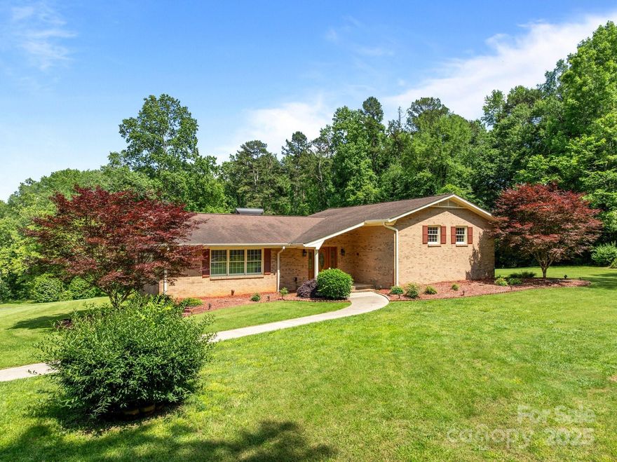 Nestled on over 5 beautifully landscaped acres, this one-owner home awaits. Inside you're greeted by a warm and welcoming foyer that flows into a formal living room and dining area, a cozy family room with fireplace, and a sun-drenched sunroom-perfect for relaxing or entertaining year-round. The heart of the home features thoughtful built-ins and charming details throughout. Upstairs, you'll find 3 comfortable bedrooms and 2 full baths, including a spacious primary suite with a WIC, convenient laundry chute, & en-suite bathroom. Down a short flight of stairs is a fantastic bonus:a second full kitchen, an oversized rec room, full bath & laundry room. Step outside to the sprawling 500 sq ft covered deck with fans-perfect for summer gatherings. You'll love the ample parking, quaint storage shed, metal storage building, and 2 bay oversized garage. Whether you're looking to establish a homestead, accommodate extended family, or simply enjoy peaceful country living, this property has it all.