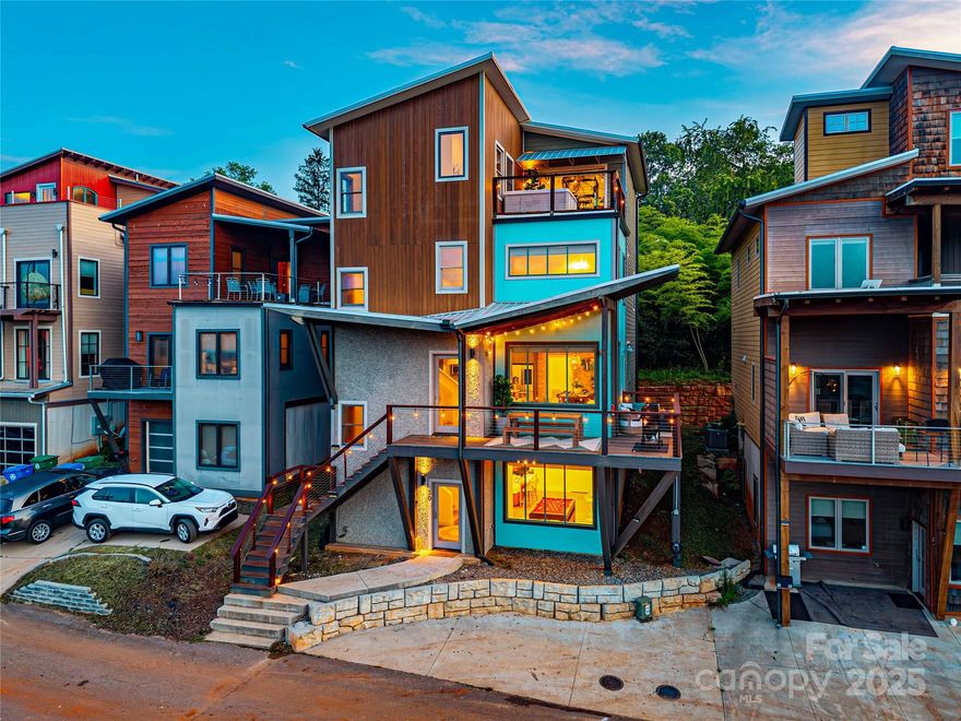 Exceptional turnkey opportunity just minutes from downtown Asheville! This fully furnished 5BR/4.5BA penthouse with a bonus room converted into an additional bedroom overlooks the French Broad River with direct views of the Biltmore Estate and is designed to host large groups with comfort and style. Currently operating as a successful short-term rental, the property can accommodate up to 19 guests and offers a proven income stream for investors or a ready-to-enjoy mountain retreat for buyers seeking a second home.

The home features multiple gathering areas, a fully stocked kitchen, in-unit laundry, and modern comforts including high-speed internet and central heating and air. Recent updates include the conversion of a half bath into a luxurious full spa bath featuring a steam shower, sauna, and cold plunge, creating a unique wellness experience within the home.

Outdoor living is a highlight with private balconies, a rooftop hot tub, and easy access to trails, river recreation, and Asheville’s vibrant breweries, dining, and cultural attractions. With strong rental history and furnishings included, this property is truly move-in and rental ready. Whether you are seeking a turn-key investment in Asheville’s thriving short-term rental market or a fully functional retreat for family and friends, this penthouse delivers the ideal blend of convenience, comfort, and income potential.