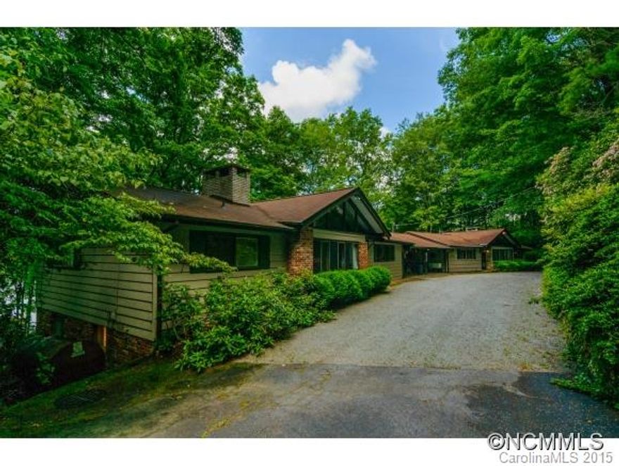 274' LAKE FRONTAGE. Rare 1.26 ac lakefront lot w/ 2 Â½ lots on Lake Toxaway PLUS 1.35 ac lot across street for future septic needs if larger home built on site. Property currently has TWO older 3BD/3BA houses connected by two double carports. Total septic capacity for 6 BD. Wonderful site for building a new large home. Property has well, rock sea wall, walk & stairs leading to two docks & boathouse w/ sun deck. HOUSES SOLD "AS IS" Multiple lots.