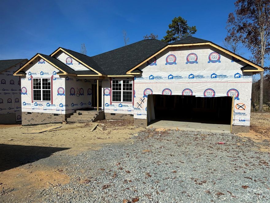 Only $1000 down to write contract! This new construction home is situated on Redbridge Golf Course in the beautiful city of Locust. This amazing 2421 sf ranch boasts a 24' x 21' family room with gas fireplace open to the kitchen and large island. This isa fantastic home for entertaining. 4th bedroom/ study with double door entrance makes a great home office. Granite countertops, tiled kitchen backsplash, stainless steel appliances, gas range, laminate wood flooring throughout the main areas and primary bathroom with 5' tile shower are all included.  Enjoy the golf course view from the 18 x 14 covered deck.  Home is in rough mechanical stage. Projected completion Jan/ Feb 2024. $10,000 in Flex Cash plus closing costs paid with use of preferred lender. All home features are subject to change without notice.  See agent for current incentives.