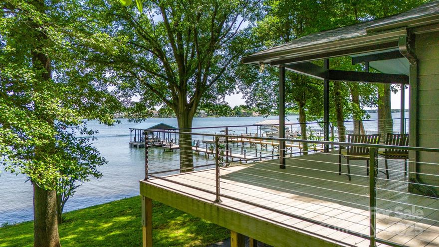 Experience Unparalleled Lakeside Living! This newly updated retreat offers expansive long range water views from nearly every room. No detail was overlooked—luxury finishes throughout make this home truly exceptional. The chef’s kitchen is a standout, featuring a 30" Bertazzoni induction oven, custom kitchen cabinets & oversized quartz waterfall island. Solid maple floors, vaulted beamed ceilings & new Windsor windows create a bright, airy atmosphere from the moment you step inside. The main-floor primary suite & two additional bedrooms offer both comfort and convenience.  The fully finished basement is an entertainer’s dream including a full bar, game/TV area, two additional bedrooms, full bath & abundant storage space. Take in breathtaking sunrise views from the maintenance-free composite deck. The new, oversized covered dock provides effortless private water access. Located in the desirable Westport community w/ no HOA, this is your opportunity to own a slice of lakefront paradise.