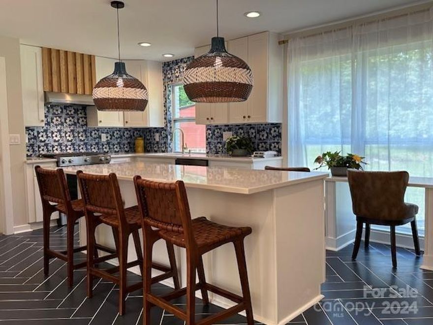 Beautifully renovated full brick home just outside Mocksville.  This better than new home features an oversized gorgeous kitchen flooded with natural light complete w island, quartz countertops and fitted with stainless KitchenAid appliances, porcelain tile backsplash & plenty of quality self-closing cabinetry.  Oversized dining area makes for the perfect family gathering place for meals.  Newly refinished original heart pine flooring, new carpeting with upgraded padding, fireplace with rustic hand-crafted mantle.  Main floor bedroom would make the perfect office, upstairs are 3 bedrooms including the master suite with walk in closet, dual vanities and roomy shower.  The basement is fully furnished with private access, separate bonus room, wet bar, full bath, and closet offering possible separate living quarters. New windows, new dual control HVAC system, new roof, 24x25 detached garage.  Too much to list!  All of this on over 3.5 acres of flat land.  Hurry, priced to sell!