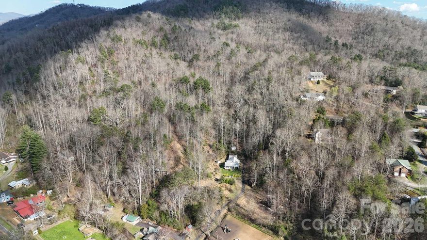 Rare opportunity to own 20.78± acres just 5 minutes from downtown Sylva and Dillsboro, NC, located directly across from the scenic Tuckasegee River. This versatile unrestricted mountain property features multiple potential homesites, a natural spring, and two existing 2-bedroom septic systems, providing a valuable head start for future construction. An existing marble stone–sided home is located on the property and may be restored, renovated, or removed depending on the buyer’s vision. A second homesite already includes a house pad and septic system. According to the steep slope ordinance, the property may potentially be subdivided into approximately 2.51-acre parcels, creating opportunities for a private mountain estate, family compound or subdivision, commercial development, or river-oriented retreat. Property has easy access to the Tuckasegee River, known for fly fishing, tubing, and recreation. Within close proximity to Asheville, Cashiers, and Highlands, this property offers an incredible combination of acreage, infrastructure, and accessibility to town in one of Western North Carolina’s most desirable regions.