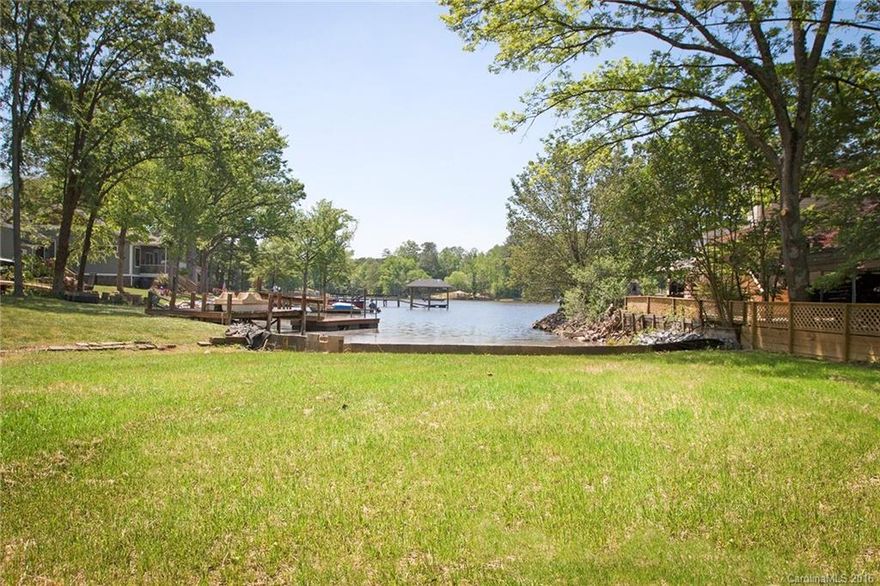 What a pretty building site for your waterfront home, with glorious lake views!  Tall hardwood trees frame the edges of this property, already cleared and ready for you to build.  Located in the heart of Lake Wylie, so convenient to schools, shopping, and restaurants.  This lot is super level for easy access to the lake, and offers a lovely view.  Owner has permit and is building a dock, suitable for you to tie your pontoon or smaller boat.  Shoreline has been stabilized with a seawall.