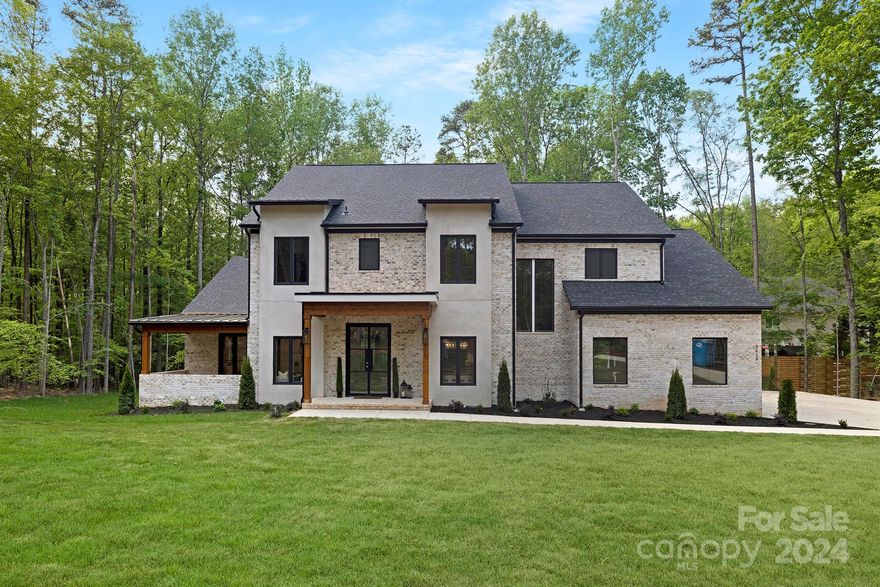 Discover elegant living in this stunning 4-bedroom, 3.5 bath custom-built home. Nestled on an acre of picturesque land, this residence is a true masterpiece. Every detail in this home exudes quality, from the upgraded finishes to the thoughtfully designed layout. Beautiful grand entrance through double 9-foot glass doors with 10-foot ceilings on main level enhancing spaciousness and 2 story ceilings in the living room creating an inviting atmosphere, this home boasts a perfect balance of openness and coziness. The heart of this home is a well-appointed kitchen where sleek countertops, high-end appliances, book matched oversized waterfall island and ample cabinetry meet to create a culinary haven. Natural light pours in through large windows, illuminating the beautiful natural hardwood floors and enhancing the warm ambiance throughout. The master suite is a true sanctuary, featuring refined details and an ensuite bathroom that exudes spa-like luxury. Don't miss this opportunity!!!!!