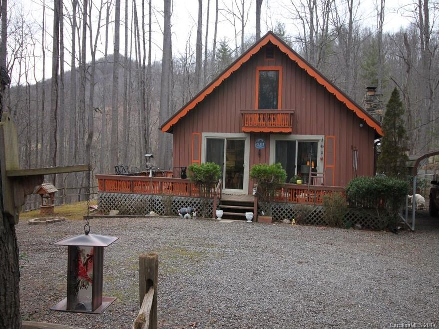 Cute mountain home on 1.1 mostly flat acres. Looks like a small Swiss chalet. Stone fireplace with gas logs for heat and ambiance. Open floor plan with loft overlooking great room. Extensive fencing on side and back yards. Located in Byrd Mtn Subdivision.  10 minutes to Burnsville shopping & 35 minutes to Asheville. New metal roof, 2 new sliding glass doors and new 5' chain link fence for pet lot!