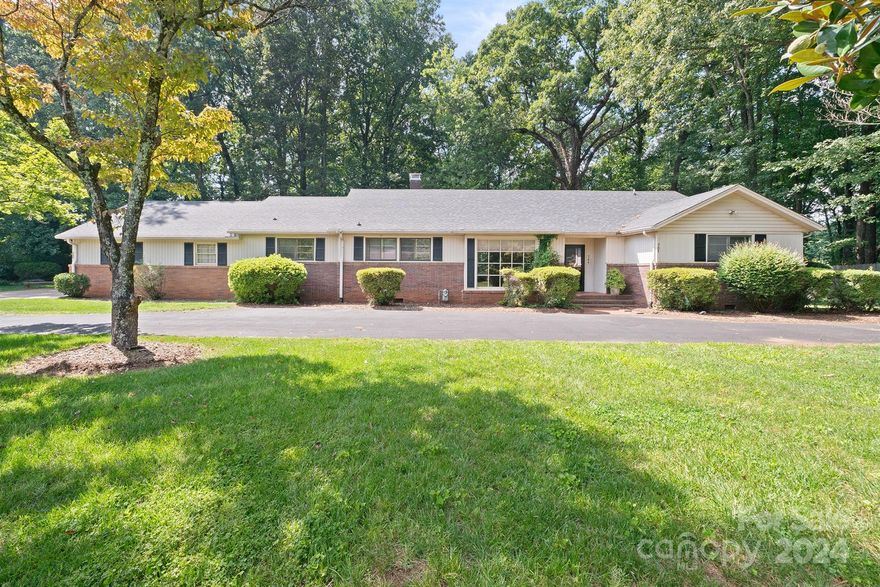 Available for quick closing.Contemporary modern one level living + attic w/additional 475 heated sq ft upstairs featuring a bonus room & full bath (not counted in HLA & total baths due to ceiling height %). Open living space with wood floors. Dining Rm/sitting rm in front with wall-to-ceiling window. Open GR w/wood-burning FP. Oversized kitchen with Spanish tile flooring, exposed brickwall,large display cabinets & desk area. 1/2 BA off kitchen. 2nd Den/Rec Rm with 2nd FP. Back hall leads to 3BRs on main or to the dutch door to take you outside the deck & patio. Primary BR with gorgeous updated walk-in tile shower, also accessible from the hallway. BR II & III share a jack & jill BA. Hallway has ample closets for storage. Wood floors throughout the BRs. Attic host full bath & bonus room. Roof 2023, side load garage, circular drive, encapsulated crawlspace, tankless water heater. Quick access to I-40 & Hwy 16. Level property in the heart of town but tucked away in Westside Development.