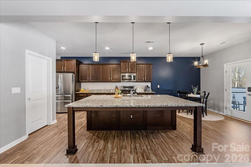 Welcome to this beautifully appointed 3-bedroom, 2.5-bathroom home offering almost 2,700 SQ FT of thoughtfully designed living space in the popular Sutters Mill community of Troutman! Nestled across from a community green space with a covered front porch to take it all in, this move-in ready home impresses from the moment you arrive. Inside, arched doorways & neutral tones with tasteful pops of color set a warm, inviting tone. The kitchen is a true centerpiece — featuring granite countertops, SS appliances, rich warm cabinetry, & an oversized island perfect for gathering & a charcuterie board. A formal dining room with butler's pantry, a spacious great room, & a flexible main-level bonus room for an office, gym, or additional place to sleep round out the main floor. Upstairs, a large loft, 2 secondary bedrooms, & a beautiful primary suite with sitting area, recessed lighting, walk-in closet, double vanity, & glass-door shower offer the perfect retreat after a long day. Step outside to your screened porch & patio overlooking serene wooded views, with a fully-fenced backyard & paver sitting area made for cool Carolina evenings by the fire pit. Community amenities include walking trails, a community garden, & RV/boat parking. Perfectly positioned between Statesville and Mooresville with easy access to I-77 (3 miles), Downtown Troutman (4.9 miles), Daveste Vineyards (6.8 miles), & Lake Norman State Park (8.7 miles). Come experience it for yourself!