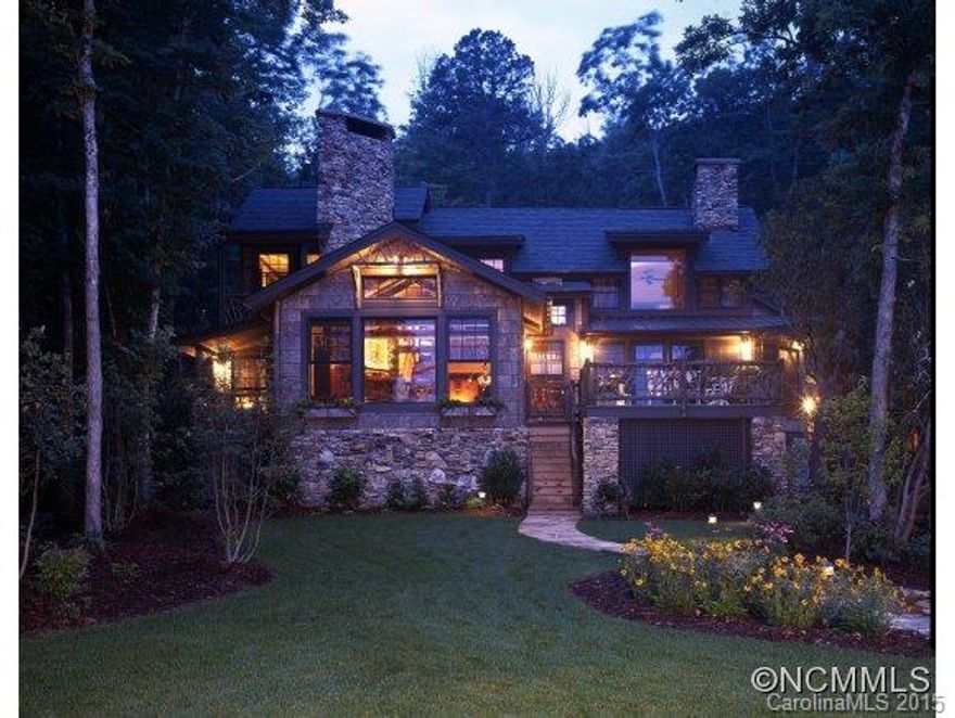 Rare opportunity to own spectacular 4BR lake home on a flat and convenient site. Rustic Adirondack design by renowned architect, Bruce Johnson. Level lake access with boathouse, seawall, and lakefront patio area complete with outside fireplace/grill. Interior living areas, master and climate controlled porch all on main level. 4 interior fieldstone fireplaces; open antique beam design; poplar bark ext. and professionally landscaped. 3 car garg.