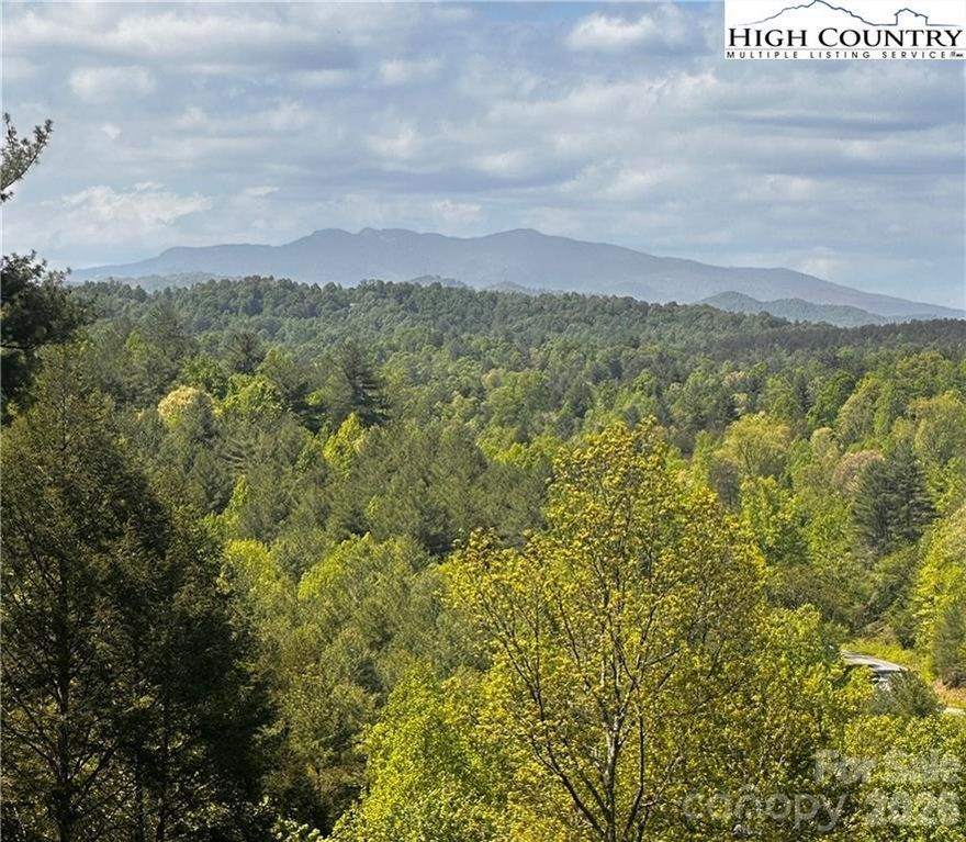 Wake up each day to awe-inspiring long-range views of Grandfather Mountain from your future home in The Coves Mountain River Club. Set on 2.01 acres, this homesite offers gently sloping terrain that provides the perfect canvas to design a custom mountain retreat tailored to your lifestyle. With paved road access and fiber internet available at the lot, it seamlessly blends modern convenience with natural serenity.

Life at The Coves Mountain River Club is defined by connection—to nature, community and adventure. The mountaintop clubhouse serves as the heart of the community, offering 360-degree views of the Blue Ridge Mountains, a fitness center, saline pool, outdoor fire pits and inviting gathering spaces. Spend your days exploring five miles of private riverfront on the Johns River, horseback riding from one of two equestrian centers, cultivating grapes in the vineyard or growing fresh produce in the community garden. With over 30 resident clubs and a full calendar of planned events and excursions, there's always something to discover—and someone to discover it with.

Ideally positioned near Lenoir, Morganton, Blowing Rock and the Blue Ridge Parkway, with 500,000 acres of Pisgah National Forest and the Wilson Creek Wild and Scenic River Area just beyond the gates, this property offers a rare opportunity to live where others vacation.