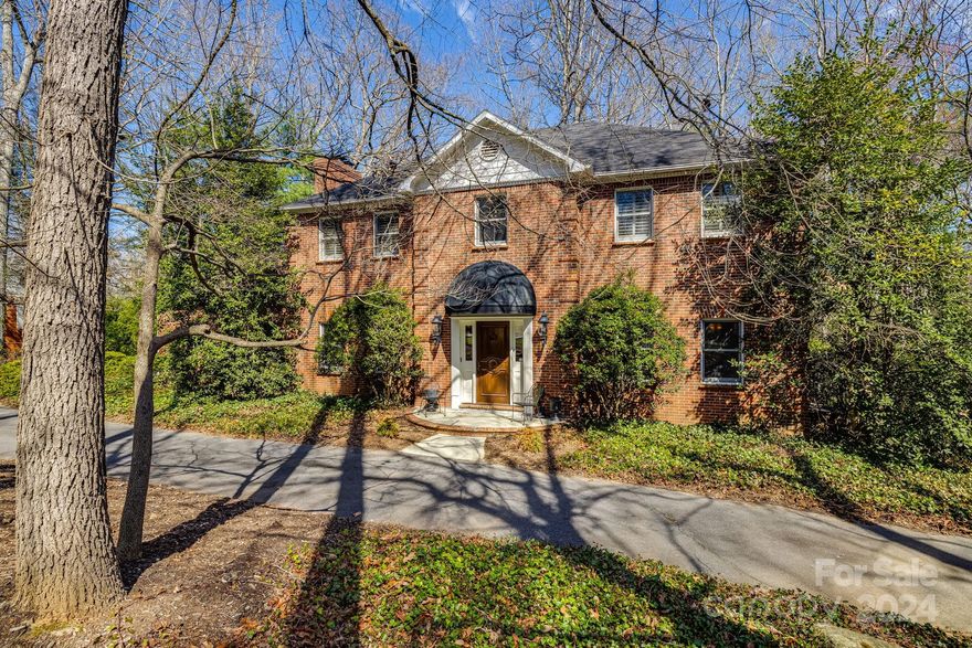 Nestled within the prestigious and storied community of Biltmore Forest, this exquisite home offers easy access to Biltmore Village and Downtown Asheville. Built in the tradition of the area's historic homes, this residence seamlessly blends timeless elegance with modern amenities. The spacious living areas are adorned with custom finishes, including intricate moldings, hardwood floors, and designer shelving. The kitchen is an entertainers dream, featuring top-of-the-line appliances, custom Cherry cabinetry, that flows effortlessly for both casual gatherings or intimate dining. The primary suite is a private retreat, complete with bonus sitting area. Whole-home backup generator, Hepa air filtration system and hot water circulating pump. Heated tile flooring, irrigation system, and underground fencing for pets. Located in one of Asheville's most sought-after neighborhoods, this home offers a rare opportunity to own a piece of history while enjoying the best of a modern lifestyle.