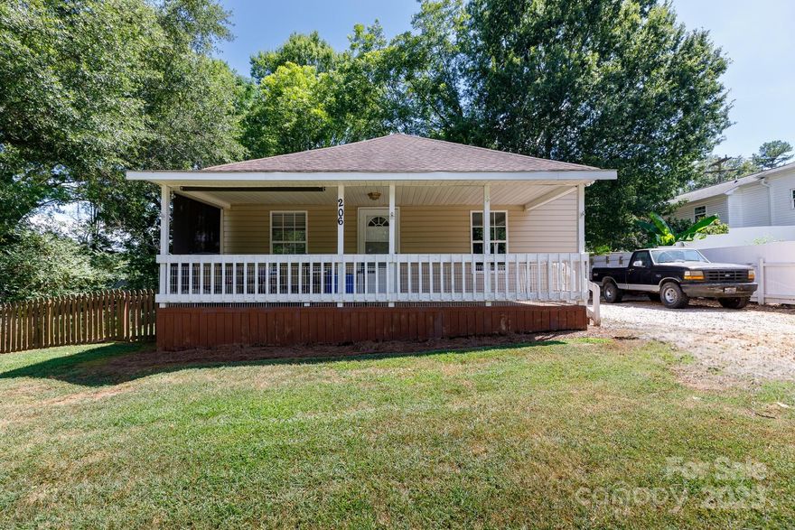 NEW PRICE ! FRONT PORCH! FENCED YARD! WORKSHOP! This charming home is perfectly situated w/in walking distance of downtown Clover and all its local amenities! Well-maintained, move-in ready, this 2-br 2-ba home features an open-concept layout, ideal for entertaining—connecting living, dining,kitchen seamlessly.Enjoy abundance of natural light, complemented by solid wood laminate flooring—no carpet! Spacious primary suite w/ walk-in clst, ensuite BA w/ dble vanities, linen closet. Dedicated mudroom w/ laundry, pantry space leads to a large back deck, perfect for relaxing or hosting guests. The fenced backyard includes a wired workshop and additional storage—ideal for hobbies, projects, or extra space.Whether you are sipping coffee on the generous front porch, or enjoying a back yard BBQ, playing in the backyard, or diving into your next DIY endeavor—this home is built for how you live.