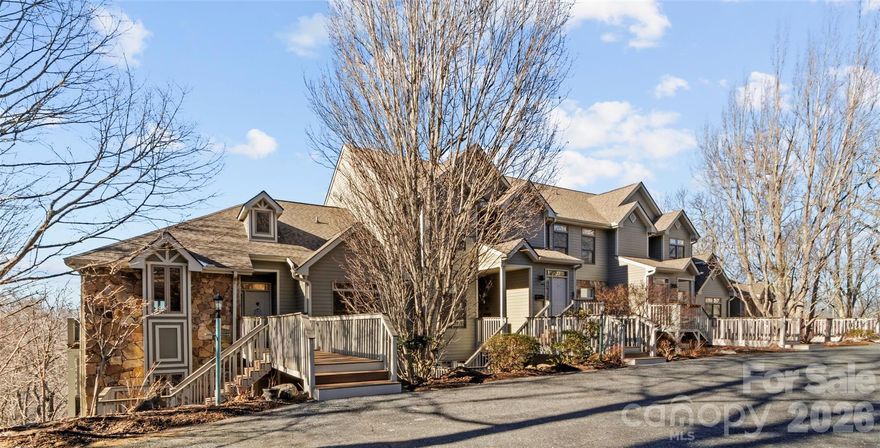 Convenience of straight-in entry with only 3 stair-steps to the front door, this great 2BR/2BA end-unit condo at MOUNTAIN AIR has breathtaking long-range mountain views. The light-filled, vaulted Great Room features plenty of windows, a stone fireplace, dining area, and open kitchen—perfect for relaxing or entertaining. The living space opens to an exceptional large covered screened porch/deck with Ipe Brazilian hardwood flooring, a second fireplace, gathering area, and stunning mountain vistas. The spacious primary suite offers two walk-in closets, en suite bath with updates, and large windows that capture the views, while the split-plan guest bedroom and second updated bath provide comfort and privacy for visitors. Enjoy cool summer temperatures from your covered deck in this ideal “lock-and-leave” mountain retreat. Offered fully furnished.