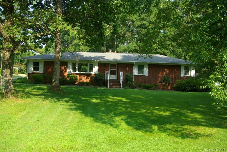 As you drive down the street and turn onto the tree dotted drive, you know you have arrived at your new home! This brick ranch has 3 large BD's, formal living room w/bay window, family room w/gas FP & built in bookcases. Step out to the sun room to enjoy your morning coffee and watch the birds. Large lot with 50 yrs of plantings. This home has hardwood floors under carpet except den and hall. Convenient to shopping & I77. County taxes, storage building 14 x 10