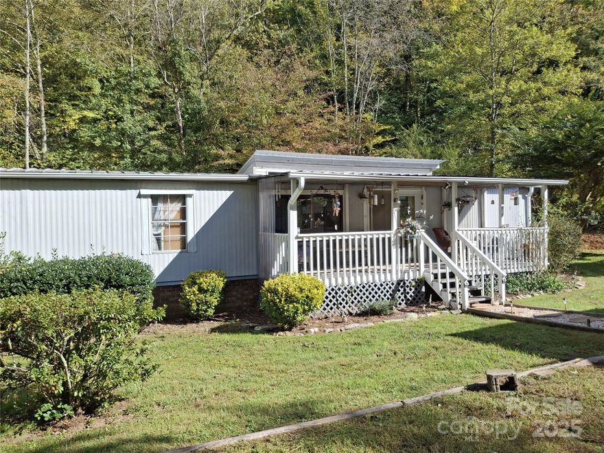 Spring is just around the corner—start the season fresh in a home you’ll love.  This beautifully updated 2-bedroom, 2-bath home featuring a split-bedroom design, open floor plan, and spacious addition, situated on 0.43 acres in the heart of apple country.

This warm and inviting property offers the perfect balance of privacy and convenience, combining peaceful mountain living with easy access. Located in a gated setting on a paved private road just off Highway 64E, the home provides a tranquil retreat while remaining only 10–12 minutes from I-26, shopping, dining, hospitals, schools, and outdoor recreation. No HOA or deed restrictions.

Inside, the home blends modern rustic style with comfort and thoughtful updates throughout. The open kitchen features a gas stove (2020), new stainless steel refrigerator, ample cabinetry, nickel fixtures, and slate flooring in the kitchen and bathrooms for easy maintenance. A convenient laundry area is located just off the kitchen.

The spacious 12' x 25' addition (new roof and ventless propane heater in 2023) offers exceptional flexibility—ideal for a family room, home office, or craft space—and features Berber carpet (2021). Additional updates include USB outlets, LED lighting in every room, all-new light fixtures, electrical outlets, switches, and Hunter ceiling fans (2021). Both bedrooms feature new carpet (2021), the front bathroom includes a new toilet (2021), and the dining area has new vinyl flooring (2021).

Outdoor living shines with a covered front porch and a brand-new 12' x 12' back deck—perfect for relaxing or entertaining while enjoying mountain views and the peaceful sounds of a nearby creek. The 0.43-acre lot offers privacy and plenty of space for gardening, pets, or simply enjoying the outdoors.

Additional features include two outbuildings and a shed for storage, covered carport parking, and a Briggs & Stratton generator. The home is mostly furnished and includes all appliances. The heat pump has been professionally serviced every six months. Recent updates include full repairs to storm-related deck damage. A FEMA engineering report is available for buyer review.

Whether you’re looking for a primary residence, weekend retreat, or investment property, this move-in-ready home offers comfort, convenience, and scenic mountain surroundings—all in one exceptional package.