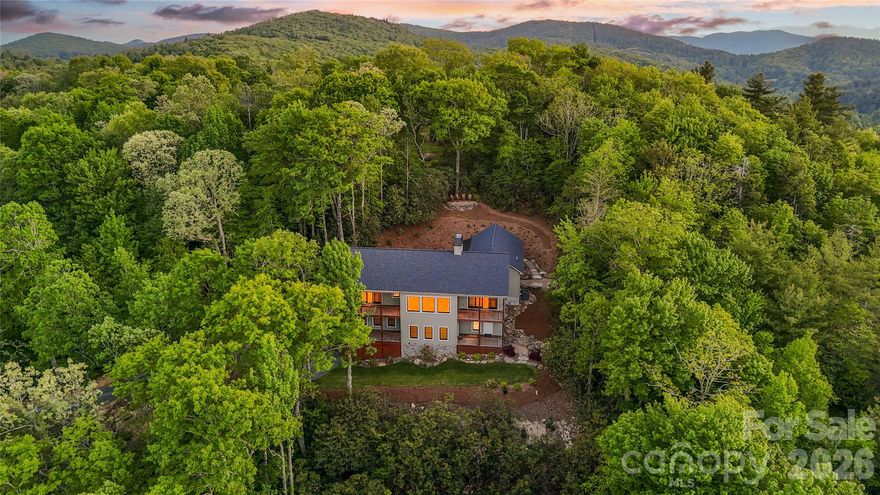 This awe-inspiring BRAND NEW mountain retreat, custom-designed home is situated at approximately 3,800 feet above sea level on over 5 acres of professionally landscaped land, offering breathtaking views of Grandfather Mountain, Flat Rock Mountain, and Hanging Rock!!  Adjacent to Pisgah National Forest, the property serves as a tranquil haven, ideal for those seeking to escape the hustle and bustle of traffic and tourists. The home is brand new and has never been lived in, providing a pristine canvas for its future owners.

Inside, the residence features 3 spacious bedrooms and 3 full bathrooms, with the main level including a private primary suite that boasts an en-suite bath featuring a curbless walk-in shower and soaking tub, as well as an additional large bedroom with a private porch and separate bath. The open-concept great room showcases 10-foot ceilings and floor-to-ceiling windows that allow natural light to flood the space, complemented by white oak hardwood floors throughout the main living area and marble flooring in the bathrooms. The gourmet kitchen is equipped with top-of-the-line appliances and stunning marble countertops, ideal for entertaining. The lower level includes a second living area with a beautiful stacked rock wood-burning fireplace, along with a bunkroom, private office, workshop/craft room, and full bath. Home is also handicap accessible. 

Notably, the septic system is designed for a four-bedroom home, allowing for future expansion, and there’s an unfinished room in the basement that is heated and cooled, making it easy to convert into a fourth bedroom if desired. The property also features five incredible covered porches with IPE decking for low maintenance, alongside winding trails through stunning rhododendrons and mature hardwoods. A picnic area with a table and fire pit is located at the headwaters of Camp Creek, leading to an incredible viewing area with panoramic vistas, making it one of the best stargazing spots in Avery County. An extra-large two-car garage comes equipped with two storage rooms, an EV charger, and a beautiful grilling patio just steps outside. Enjoy the security of a gated property with no HOA fees and low county taxes, all just minutes from Linville, N.C., Grandfather Mountain, Linville Falls and Gorge, the Blue Ridge Parkway, and Pisgah National Forest. Additionally, there is a designated site for a second home, providing an exciting opportunity for additional living space, whether for guests, rental income, or future family expansion, enhancing the value of this unique retreat in a serene mountain setting!!!!