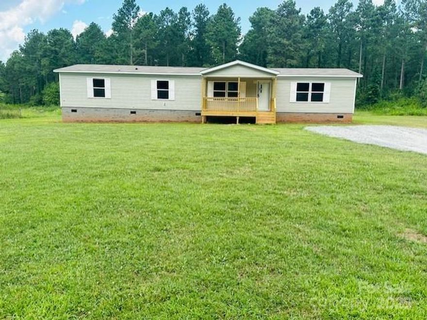 Check out this BRAND NEW 4 bedroom, 2 bath double-wide on over 1.2 acres. If you are looking for space, you have it here!   As you walk up the new covered deck, you enter the front door into the living room area. Your primary master bedroom and bathroom are located on one side of the house, where your additional three bedrooms are located on the other end. This property offers an open concept with the living area, kitchen, dining, and family room. The kitchen includes all new appliances, refrigerator, dishwasher, and oven. You have plenty of outdoor space for entertaining, gardening, etc. House comes with a Warranty! This will not last long!