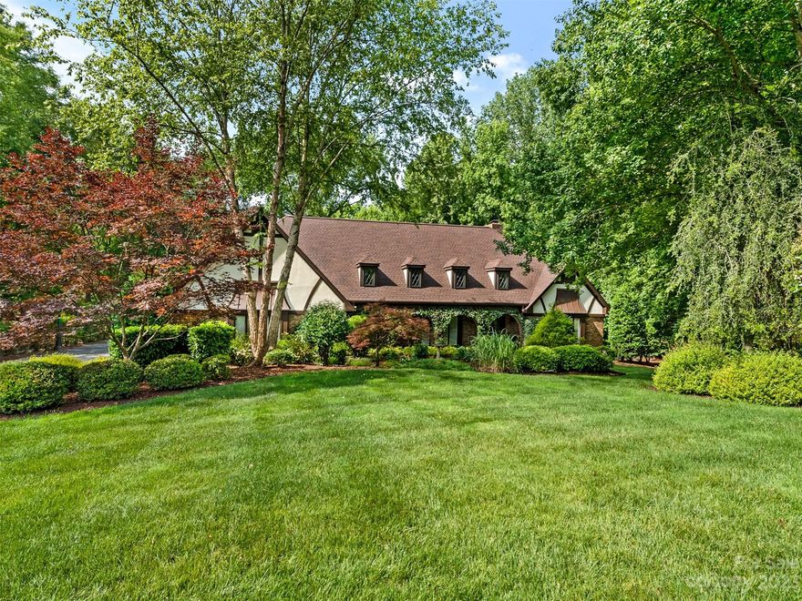 Special opportunity to live on 1.26 acre tranquil setting just steps to Carmel CC. Featuring 4365 sq ft, 4 car garage, 4 spacious bedrooms each with ensuite bath plus walk in closets, this home also offers plenty of options to add a pool. A Chef's kitchen includes 48" Wolf gas range, SubZero refrigerator, copper sinks, ice maker and wine cooler. From the gas lanterns to the koi pond, to the NEW roof and gutters (May 2023), there is thoughtful design inside and out with abundant space and attention to detail. Enjoy the privacy from your sunroom and rear patio built for entertaining including a fireplace with built in BBQ oven. The back staircase leads to a spacious bonus room with Epson home theater, and built in fridge/freezer. Don't miss the second office/hobby room! NEW primary bath. Hickory hardwood flooring, tankless water heater, no HOA, well for irrigation, garage workshop, multiple walk in storage areas- the details in this home create a South Charlotte Gem!