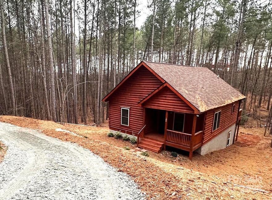PRICE REDUCED!  New construction Blue Ridge Log Cabin located just outside of Lake Lure.  Location is only about 4 miles from the water's edge of Lake Lure.  Two bedrooms, 2 full baths, kitchen and living room with dining area all on the main level.  The kitchen and both bathrooms have black onyx granite counter tops, and kitchen has all stainless steel appliances.  The stove, microwave, refrigerator and dishwasher are included with the sale of the house.  The living room has a gas log fireplace with stacked stone.  Fuel tank is leased. The full unfinished basement is plumbed for a third bath.  The 3 Bedroom septic permit will allow for future expansion in the basement.  The washer and dryer hookup is located in the basement.  There is an 8 foot wide deck on the back of the house.  Yearly dues is $375.00 for road maintenance.  Vacation rentals allowed.  Convenient to Chimney Rock State Park & many points of interest in Western NC.