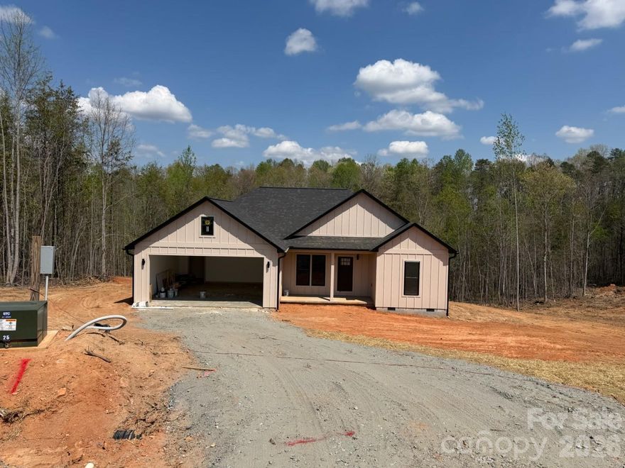 Beautiful new construction on 1.68 acres offers modern style with a farmhouse flair. This home boasts an open living floor plan, high ceilings and stylish details. Beautiful Pella windows flood the home with natural light. A stunning cook's kitchen with stainless appliances and quartz countertops. The Primary bedroom has an en-suite bath with beautiful custom tile shower and double vanity. This is the largest lot in the neighborhood! Many of trees were left in the rear of the lot for added greenspace. The mostly level lot is perfect for outdoor entertaining, gardening or maybe a future hot tub! Nestled in a country community that will have a maximum of 8 homes at completion. Deed restrictions are minimal and NO HOA! Close proximity to all necessities like gas and groceries and only 4 minutes to the Tryon International Equestrian Center. TIEC houses events and amenities like equestrian activities, concerts, seasonal specials, dining, lodging, shops and even a fitness center. Additional lots and house plans will be available. Located just off Moore Rd in Tryon. Use 1265 Moore Rd (next door) for GPS purposes if needed. Look for the development entrance. Please contact listing agent with questions.