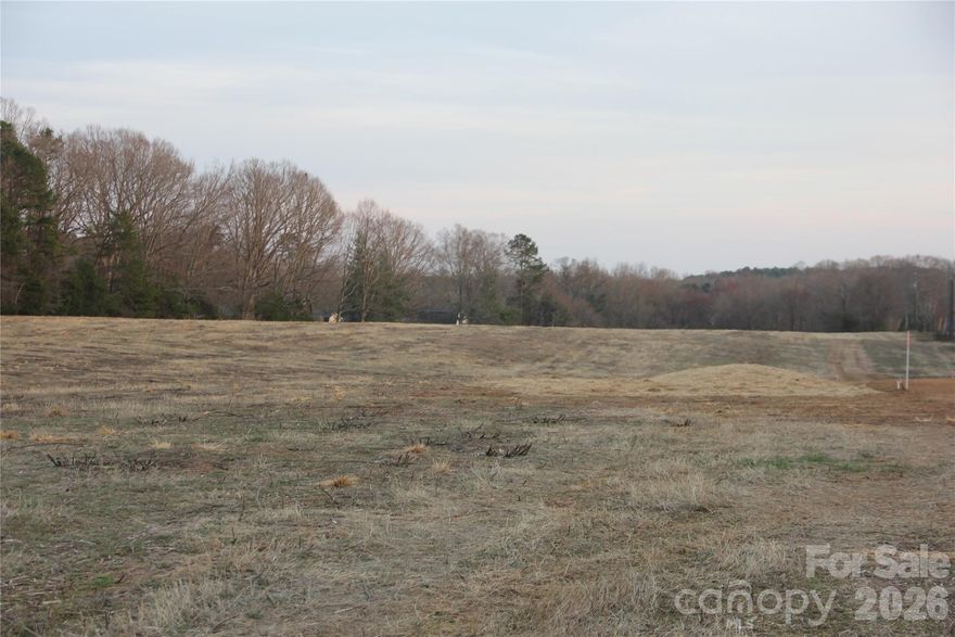 Rare opportunity to build your dream home on 4 beautiful acres in a highly desirable location off Pagemont and Tuckaseegee Roads. No City Taxes! This homesite is part of an exclusive five-parcel estate setting, with custom homes to be built by the accomplished team at Wightman Custom Homes. Perc testing has already been completed confirming suitability for a 4-bedroom home, providing the ideal foundation for your custom estate.