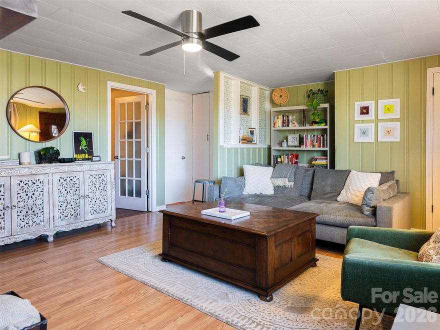 Heart of Mills River! This inviting 2BR/2BA home sits on a gentle .64-acre lot. Features include a bright dining room, gas-log fireplace, and an updated kitchen with quartzite countertops leading to an all-season room. The spacious primary suite offers a recently renovated bath and screened patio access. Includes a large flex/office room, expansive back deck for grilling, carport, and storage shed. Unbeatable location near shopping, DuPont, and Pisgah National Forest. Move-in ready mountain living.