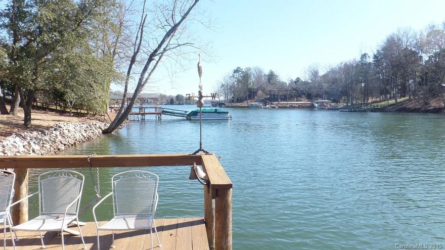 Rare opportunity for a deep water location/lot that is NOT part of the Tega Cay Development.  Existing home is a 3 bedroom, 2 bath home and can be lived in--but the lot is perfect for a much more grand structure.  Other homes on the street are in a higher price range.  Great access through the nicest part of Tega Cay with great frontage and beautiful views of the lake.  Boat lift by floating dock--entire front of lot is totally rip-rapped. Private cul-de-sac lot on Point.