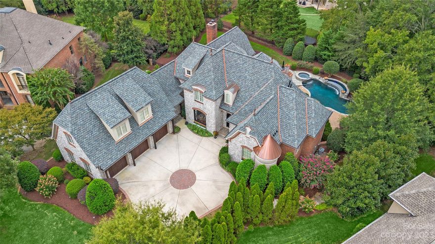 ABSOLUTELY STUNNING estate home in the prestigious gated community of Providence Downs South! Custom built by New Traditions. MAIN level-oversized owner's suite w/ plenty of closet space, spa like owner's bath w/lrg soaking tub, huge walk-in shower w/dual heads & rainfall shwr, bench seat. Gourmet kitchen-Wolf 60" Duel Fuel range/hood(2022),Wolf microwave(2022),Sub Zero under counter fridge/freezer combo drawer(2022),Marvel wine fridge(2022),Sub Zero fridge(2017). Sitting room w/one of several custom stone fireplaces.Huge dining rm. Formal living rm w/great views. Butler pantry. Laundry. UPPER level- huge living rm/loft,2 BR's-both w/private bths. Enormous bonus rm w/private bth & separate staircase. LOWER level- second kitchen, billiard rm, gym, sitting rm w/FP, luxurious BR w/ensuite bth, huge theatre room (2023) equipment. Backyard oasis w/breathtaking pool area, flaming urns, waterfalls, fireplace. Designer roof w/copper valleys & turret (2023). 2 HVAC's (2017,2018).Marvin Schools!