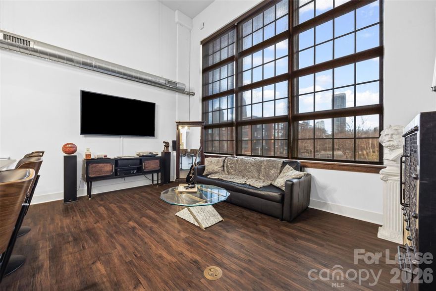 Stylish condo with stunning city views and dramatic floor-to-ceiling windows. Features a loft-style primary suite on the top floor with ensuite bath including shower and tub. Main level offers a second bedroom, full bath with laundry, and open-concept kitchen and living area. Enjoy premium rooftop access with outdoor entertaining space, fireplaces, equipped kitchen, grills, and views of local fireworks. Secure building with integrated technology, secure lot and garage access. 1 assigned parking space + 1 guest pass included.