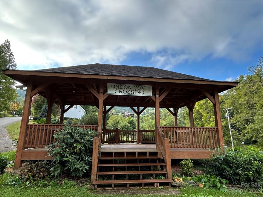 Priced below tax value!  Want to escape the busyness of it all?  Come to Lindon Cove, where peace and quiet await.  This community offers amazing mountain and valley views along with a large field area (Ryan Park) at the entrance on left boarded by Hominy Creek that allows the residents an area to spend time together outdoors or let the pets stretch their legs.  Also, to the right of the entrance is a large Community Gazebo, perfect for getting out of the weather and enjoying the day or waiting for the bus.  These two lots combined offer room to build and still have an area to enjoy a nice yard or small garden.