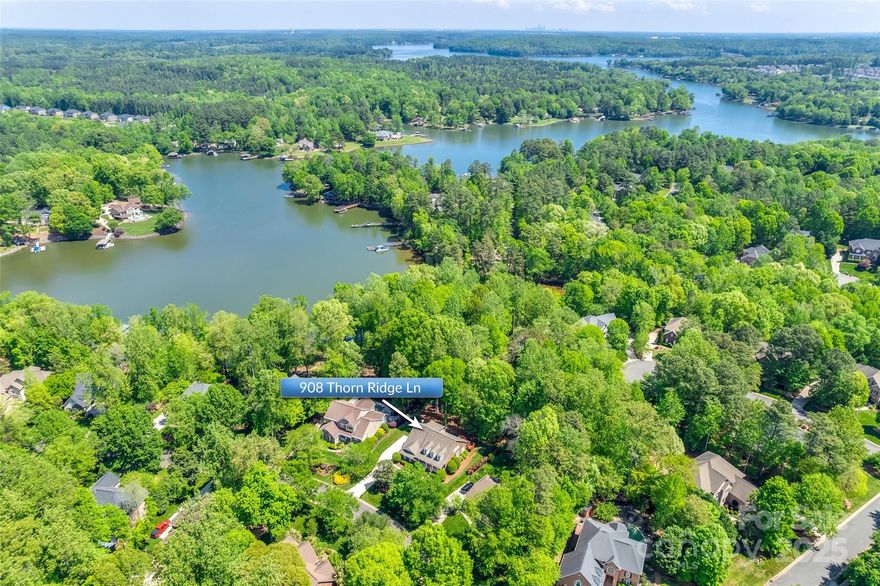 This beautifully maintained home with deeded boat slip in The Landing on Lake Wylie offers an exceptional lifestyle. The main level features a spacious primary bedroom, office, breakfast area, well-appointed kitchen, laundry room, & a great room that boasts a cozy gas fireplace. Step outside to a rear deck ideal for grilling or enjoying breathtaking lake views. The inviting covered front porch is perfect for unwinding with a book. Upstairs, you'll find two additional bedrooms, a full bath, and a versatile loft area that can serve as a second office or play space, plus ample walk-out attic storage. The basement is a standout, featuring a cozy living room w/gas fireplace, opening into a recreational area designed for pool table fun. It also includes a bathroom and a flex room that can be used as an office, rec space, or bedroom (though no window). With plenty of storage options, award-winning schools nearby, and easy access to the community pool and boat slip, this home truly has it all!