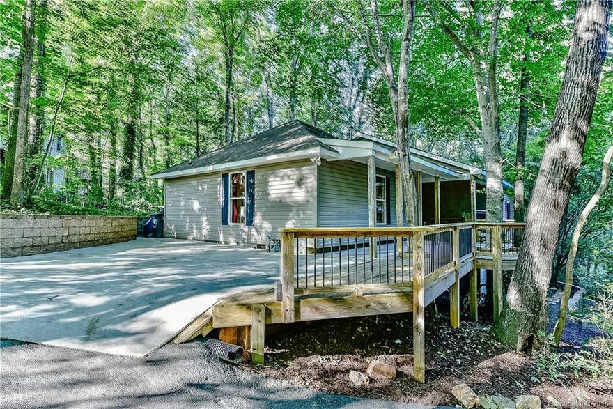 Vacation at home! This one is a wow! Tucked away with covered and open decks, one with a hot tub to soak away the days stress in private luxury. Once inside the open living with grand picture window invites the outside in. New kitchen, hardwood floors, 4 bedrooms with two master suites (or make one a recreation room), renovated baths, tons of storage under the house....extraordinary living!