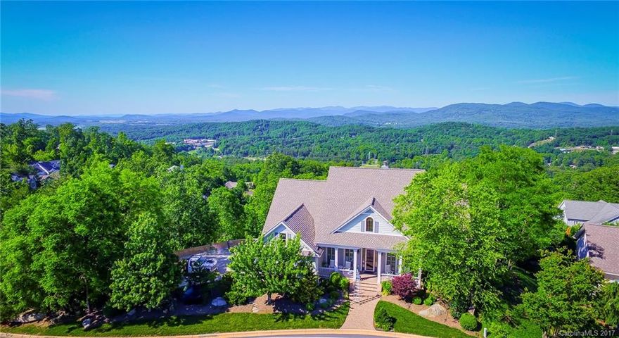 STUNNING LONG-RANGE MOUNTAIN VIEWS INCLUDE MT. MITCHELL!  Custom home designed by Architect, Stephen Fuller features two private decks, cathedral ceilings, extensive moldings, Pella windows and quality throughout.  Main level living /w 2nd level Guest Suite.  Lower level c/b home theater, fitness area and/or entertainment space. Two exterior entrances and private mini garden.  Community clubhouse, indoor pool, tennis!