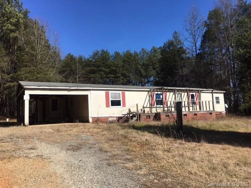 Looking for Roamin' Room? Be nature's neighbor on this 2ac home site with many possibilities. Site currently has a doublewide mobile home with addition that is of no value. Buyer will need to have structure demolished or moved due to encroachment on adjacent property.