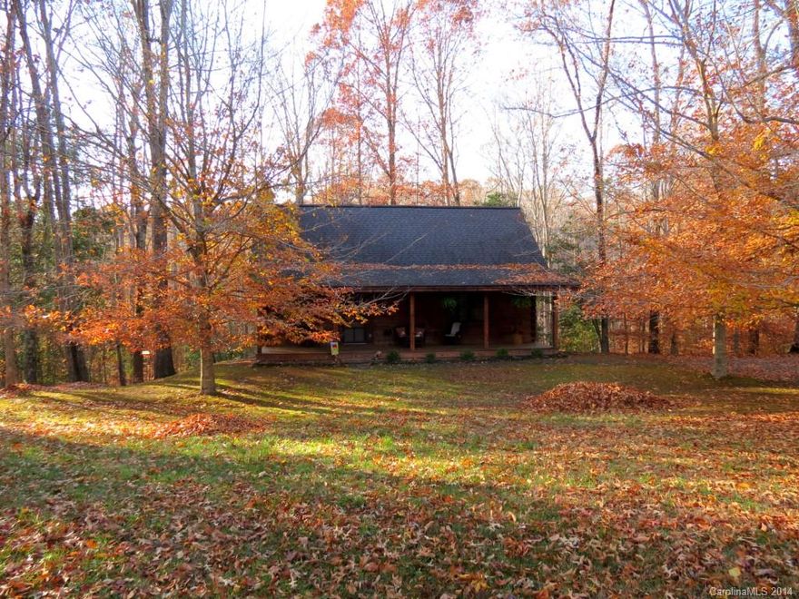 Classic log home nestled in the trees.  Great room with rock fireplace and beautiful wood floors.  Kitchen with custom hickory cabinets.  All applicances included.  Energy efficient double pane windows.  Back deck and hot tub.  Wooded lot sloping to creek offers great privacy.  Rocking chair front porch.  Basement offers exra living area, garage and work room.  Low electricity costs.  Great location near schools, dining and shopping.  If you have always wanted a log home, here is your chance!