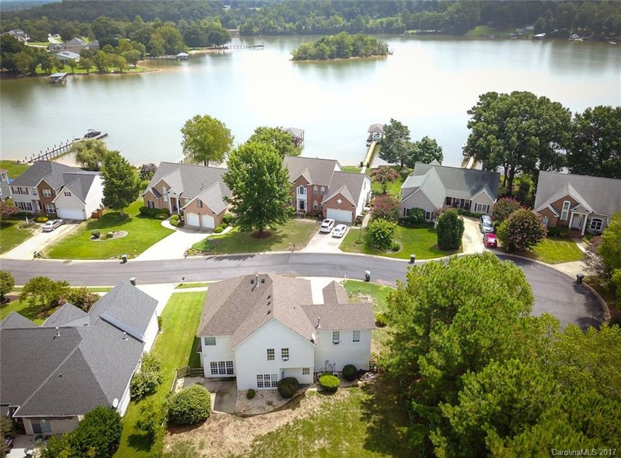 Just under 3000sf, 5 bedroom, 2.5 bath within steps of your own Deeded Boat Slip in Harbor Cove for under $350,000. Freshly painted, newer hardwoods, kitchen backsplash and a carpet allowance with full price offers! Private backyard, good elevation and fenced yard for the pets. Come look at this this home ASAP. We are buttoning up the last of the improvements and cleaning and will upload interior shots by August 28th. Harbor Cove is centrally located & convenient to the growing features of LKN!