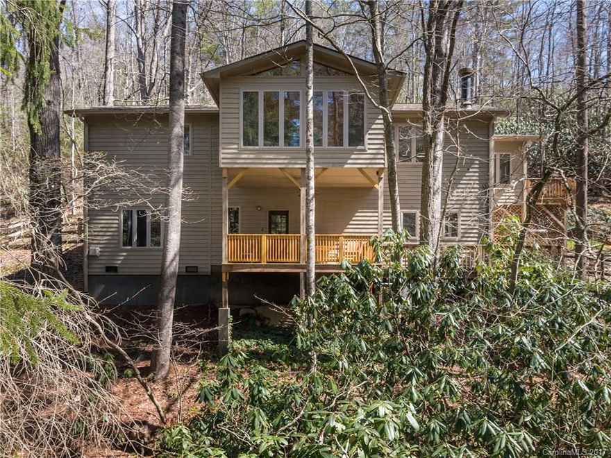 Nature and privacy abound on this unique property situated on 5 acres enveloped by rhododendron & mountain laurel. Main level features heart pine floors, vaulted ceilings, great room w/ stone gas fireplace, kitchen w/ quartz countertops, heated/cooled sunroom, dining rm, master suite, office & laundry. Elevator takes you to the LL guest suite w/ separate outside entrance. Overlooks pond and cascading creek. Multiple deck areas & fenced courtyard. Enjoy nature at your doorstep.