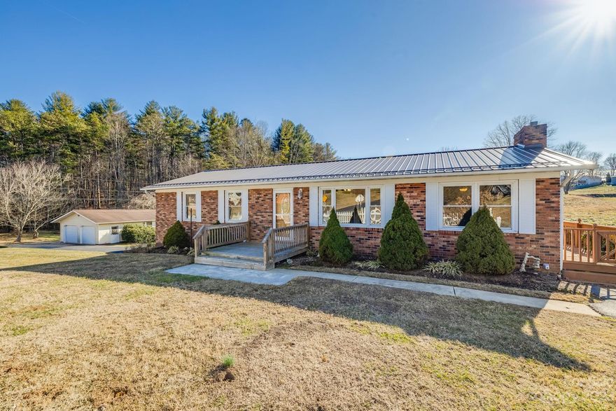 Exceptional opportunity to own a versatile home just a short 15-minute drive from downtown Asheville! This property boasts two separate living quarters with 2 kitchens and ample living space. The upper level features 3 bedrooms / 1 bathroom, a living room plus a den, while the lower level has been completely remodeled to offer 3 bonus rooms and 2 bathrooms. With OU zoning, the property offers numerous possibilities for use. Ample parking, a seasonal creek bordering the property, large flat area perfect for gardening, whole-house generator, and - best of all - a spacious 24 x 32 oversized 2-car garage, previously used as a workshop, are just a few of the amazing additional features this property has to offer! The seller is offering a $5,000 credit for deck and sunroom repair/removal. Don't miss out on this all-inclusive home!