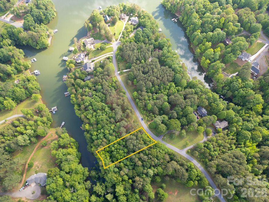 Discover the perfect blend of privacy and lake living with this 0.6-acre waterfront lot in the gated Riverwalk community on Lookout Shoals Lake in Stony Point, NC. Tucked away at the end of a peaceful cove, this wooded lot offers easy water access—ideal for fishing, kayaking, and canoeing, though water levels may vary. Residents enjoy many amenities including a private beach, community boat ramp, boat slip, and storage area. Conveniently located near Hickory and Statesville, with Charlotte just about an hour away, this lot offers both serenity and accessibility.