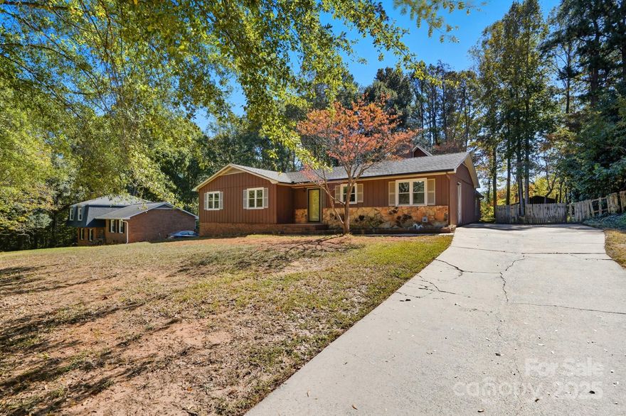 Welcome to this charming home, tucked away in Fort Mill's coveted Foxwood neighborhood, with no HOA and almost a half-acre to enjoy. Priced to reflect both its charm and potential, this 2700 square foot home offers single-level living with a bonus room upstairs, a perfect space for a home office, playroom, or guest retreat. The open and inviting floor plan features a cozy living room with an aesthetically pleasing stone fireplace, a bright kitchen with plenty of cabinet space and a split bedroom layout for added privacy. 4-5 bedrooms and 2 full baths offer maximum versatility, and there is plenty of flex space to use how you desire. The entire interior has been freshly painted, and new laminate floors flow throughout the main living spaces. Located just minutes from top-rated Fort Mill schools, the Anne Springs Close Greenway, shopping, restaurants, and easy access to major roads.