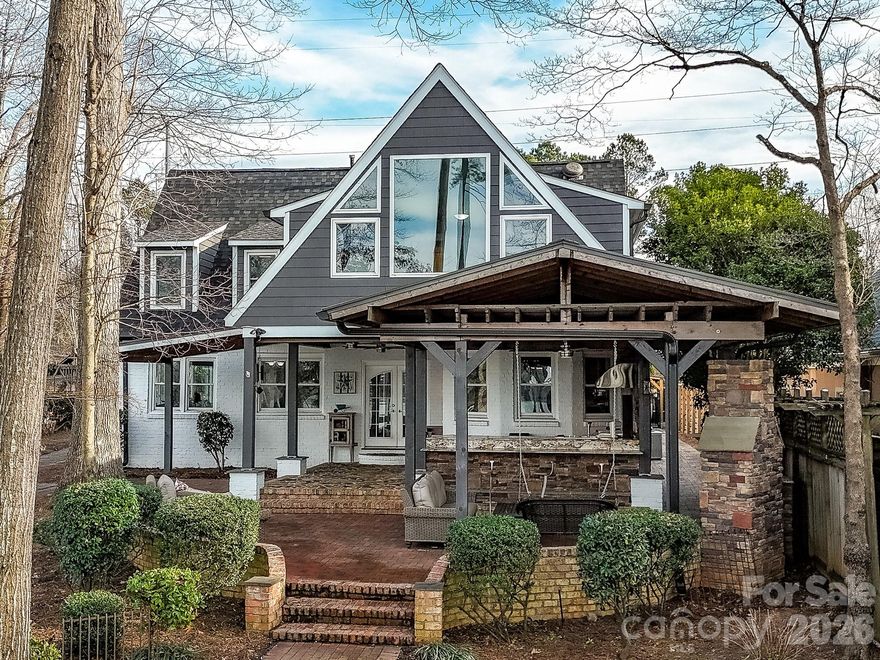 Extraordinary Waterfront Living on Mountain Island Lake. It's all about the Lake!
An Outdoor Oasis & Entertainer’s Dream!
Tucked discreetly away from the street as close to the water as possible, this one-of-a-kind luxury waterfront estate delivers what lake living is truly about—unparalleled panoramic views of Mountain Island Lake. With commanding sightlines across open water, the home faces the protected shoreline of Latta Nature Preserve’s 1,500 plus acres, ensuring lasting privacy and freedom from future congestion. Approximately 20 minutes from Uptown Charlotte, this property offers the ideal balance of resort-style escape and everyday convenience.

Designed around a striking Fire and Water theme, the home was crafted for elevated entertaining indoors and 
out, with abundant parking as part of turnaround asphalt driveway and golf cart path and thoughtfully curated spaces throughout.

Outdoor Oasis – Resort Living at Home -
The property rivals a five-star resort, anchored by a stunning saltwater pool and hot tub with expansive walk-in steps and dramatic gas fire features. A swim-up bar with submerged bar stools invites relaxation, while covered 
bar and lounge areas provide dining, seating, and a large-screen television—perfect for game days or evenings 
by the water.

Two outdoor kitchens elevate entertaining, including a restaurant-quality gas griddle and hood with dual warming drawers on the lakeside. A charming gazebo features two water elements—an elongated fountain and a rock-stone fountain—centered around a wood-burning fire pit. A glamping-style guest cabana with mini kitchen offers a 
unique poolside retreat, while an herb and specialty flower garden space adds fragrance and culinary inspiration.
Poolside convenience includes direct access to an oversized bath with dual lavatories, dual showers, and hand-selected ornate grained granite.

Waterfront Excellence – A Dock Like No Other -
Newly constructed including new pilings, massive two-tier, double-decker dock built with Trex-style materials offers carefree lake enjoyment. The upper level features Gutter Deck waterproof decking, engineered to stay cooler with superior water-wicking properties—perfect for morning yoga, workouts, or sunset gatherings. The terraced lower level includes a boat lift with 10,000 lbs capacity for your luxury boat. A Rotomag jet ski lift rotates your jet 
ski to the perfect position, complete with its own access ladder. Extra-wide stairs for kayaks and paddleboards, 
and a golf-cart path connecting the home to the dock. A lakeside landing with porch swing provides a peaceful 
place to take in the views.

Interior – Modern Renovation with Artistic Detail -
Inside, stone accents, blonde wooden beams, and a warm modern aesthetic continue the Fire and Water theme. Artisan-bleached stonework in den adds refined texture, while the chef’s kitchen features top-tier appliances, luxurious leathered Quartzite counters, and a bay window framing lake views. Second laundry area on main level  for pool convenience.

Bedrooms & Flexible Living Spaces -
The upstairs primary suite showcases breathtaking floor-to-ceiling windows with ensuite bath. A second upstairs oversize bedroom with a hall full bath with laundry area. A third bedroom, currently utilized as an oversized 
custom closet, easily converts back. Above the three-car garage, a fourth bedroom functions as a private 
apartment with sitting area and modern cabinetry and half bath.

Additional Features: three-car garage, lake-fed irrigation, Sonance outdoor audio via Sonos app, and EEROS 
WiFi booster for seamless outdoor connectivity.

This is not just a home—it is the premier offering on Mountain Island Lake, where luxury, privacy, and 
unforgettable entertainment converges. American Home Shield Warranty included. New roof 2025. Private HOA Community Boat Ramp access.