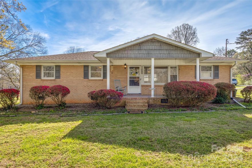 Welcome home to 1107 Lane Rd, Mount Holly, NC! This charming 3-bedroom 1-bath brick home sits perfectly on a nice half-acre corner lot. As you step inside, you're immediately greeted by the home's warmth and inviting atmosphere. The residence boasts stunning hardwood floors that flow throughout most of its floor plan, adding a touch of elegance and timeless beauty. You'll be struck by the abundance of natural light that floods the interior, creating a bright and airy feel that uplifts the spirit. The enclosed carport area is a highlight, basking in sunlight and offering versatile space for relaxation or hobbies. Venturing outside, the property features a generous 2-car detached garage and an expansive workshop. Though nestled in a serene setting that gives it a delightful country ambiance, this home is merely minutes away from the vibrant heart of downtown Mount Holly and the quaint charm of neighboring Belmont. This gem won't stay on the market long, so schedule your showing today!