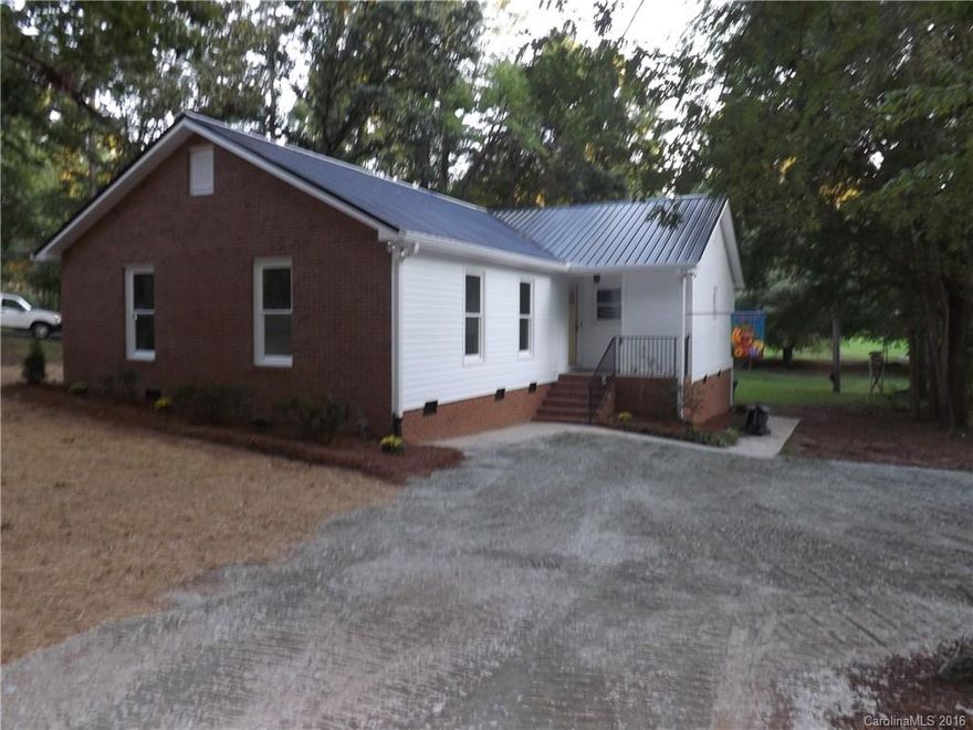 Home shows like new construction!!! New metal roof, new windows, new vinyl siding, totally redone screened porch, new cabinets in kitchen with granite counter tops and subway tile back splash. Home also features large great room/dining area  with masonry fireplace with new flooring. 3 bedrooms with new carpet and 2 baths with new vanities and fixtures. Home is in area that qualifies for USDA 100% financing for qualified buyers. Close to Wingate University. Located in College Park.