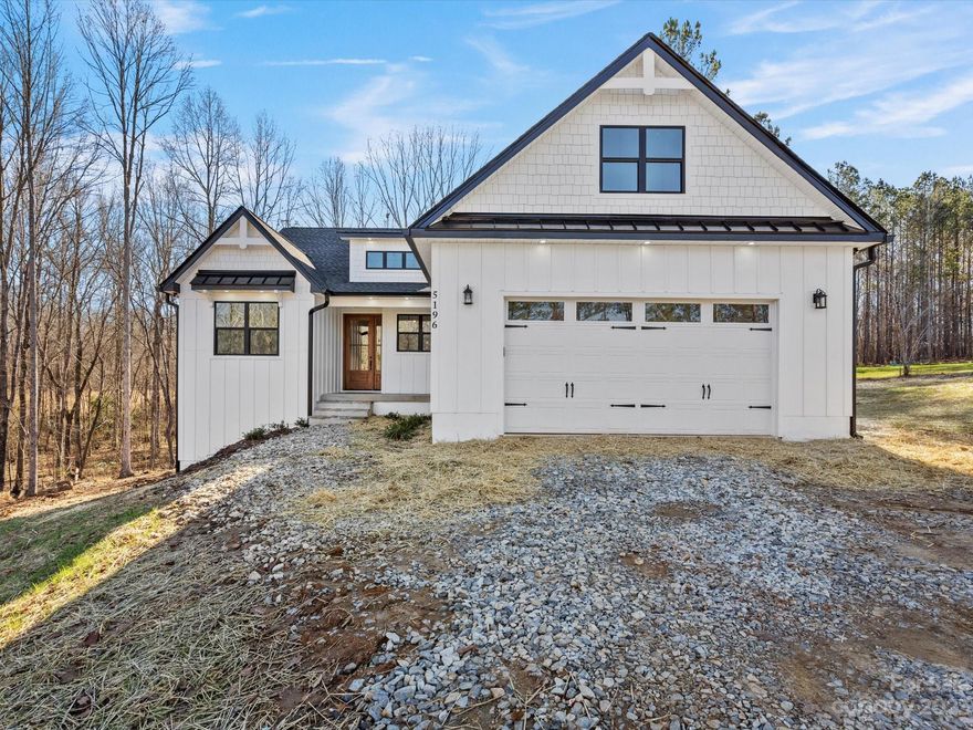 Stunning NEW CONSTRUCTION home with walk-out basement sits on 6.23 acres and offers a split plan with three bedrooms, two full bathrooms, living room, kitchen, dining area, laundry room and walk-in pantry on the MAIN LEVEL. The luxurious primary bathroom includes a large custom tile shower, soaking tub, double vanity and walk-in closet. The two secondary bedrooms share a full bathroom. The kitchen includes custom white cabinets, eat-on island, custom range hood, quartz countertops, tile backsplash, and walk-in pantry. A fireplace with gas logs and vaulted ceiling complete the open living area. The dining area's large windows provide a spectacular view of the backyard and wooded lot. Walk-out FINISHED BASEMENT offers ANOTHER bedroom and full bathroom, flex room, and living area. LVP flooring throughout main level and basement. Large covered porches on the main and lower levels provide additional space for outdoor living and entertaining.