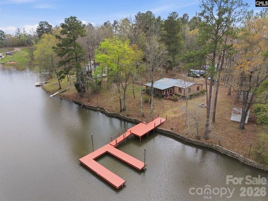 Lake Wateree! 3-bedroom, 2-bath manufactured home situated on 0.71 acres of beautiful waterfront property. This home features a split floor plan, offering privacy and comfort for family or guests. All appliances are included for a move-in-ready experience. Enjoy outdoor living with a spacious patio and deck overlooking the water—perfect for relaxing or entertaining. The property also a private pier with a floating U-shaped dock, ideal for boating, fishing, or simply taking in the peaceful surroundings. MH title is retired.