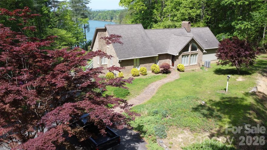 Beautiful 3 BR 3.5 BA home with lake access, magnificent view of Kerr Scott Lake, and mountain views beyond the lake. Sit on the deck or the screened-in porch and enjoy the beauty of nature. The home has cathedral ceilings in the Great Room with a mountain-style rock fireplace. The room opens onto the deck and the screened-in porch. The Great Room has hardwood floors. The kitchen features lots of cabinet space, a double oven range, a large refrigerator, and a new dishwasher. The primary BR is quite large with great lake and mountain views and a large walk-in closet.  There is another BR on the main level with a full BA and a 3rd BR next to a full BA in the hallway which includes a utility area with W-D hookups The upper level has a loft that overlooks the Great Room. It can be used as an office or even a sleeping option since it has a .5Ba and closet space. The basement provides parking and plenty of storage/workshop. This beautiful home offers privacy, lake access, and great views.